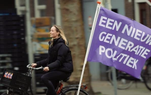 Volter riding a bike with a flag saying 