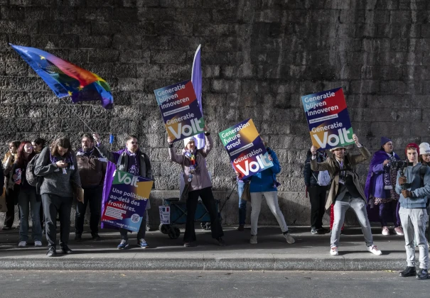 Volters with flags and cardboard banners in a tunnel