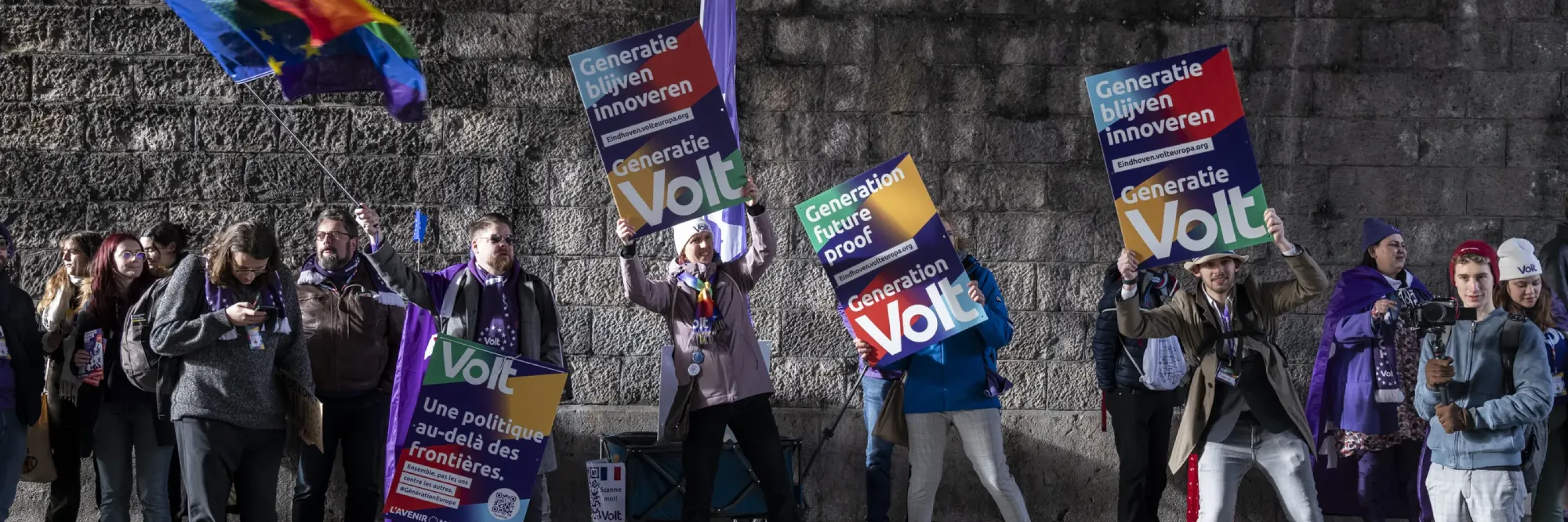 Volters with flags and cardboard banners in a tunnel