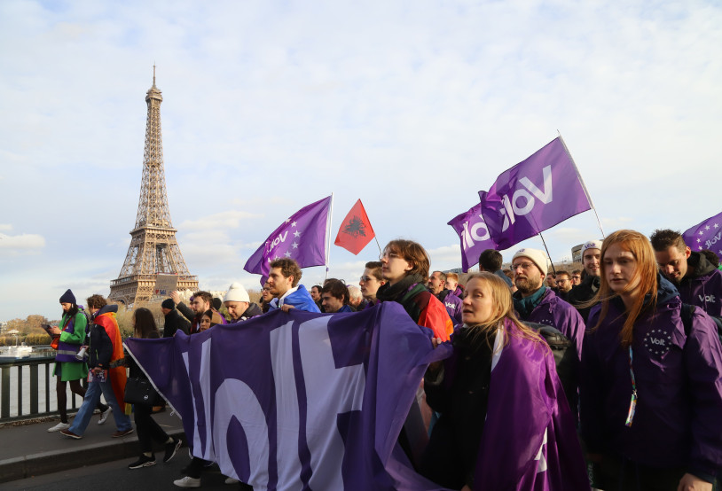 Group of Volters marching on the streets of Paris with the Eiffel Tower on the background